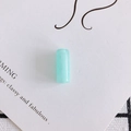 Detailed view of a mint green cylindrical resin bead with a polished finish for DIY jewelry - Large / Blue