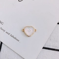 Macro detail of heart-shaped gold-rimmed charm with white glitter for DIY jewelry making - Pure White (6#)