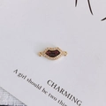 Detail of lip-shaped gold pendant with cubic zirconia inlay and red glitter finish - Style 1