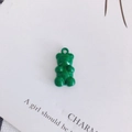 Detail view of a bright green resin gummy bear pendant with a metallic hanging loop - Bright Green