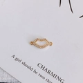 Detailed macro view of gold-plated lip pendant with opal inlay and sparkling zircons - Size 6