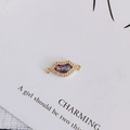 Detailed view of gold-plated lip charm with zircon inlay and colorful glitter center - Size 7