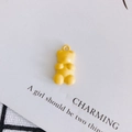 Close-up of a yellow resin gummy bear pendant with a top ring for DIY jewelry making - Yellow