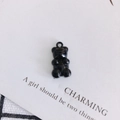 Detailed close-up of a glossy black resin bear charm with a ring for DIY jewelry making - Black