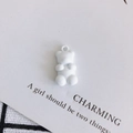 Detail of a matte white bear pendant with a top hook for DIY jewelry making and crafts - White