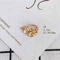 Detailed view of an irregular wavy golden pendant with five small inlaid diamonds - Wave Design (2#)