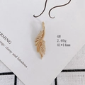 Detailed macro view of a gold-plated feather pendant with sparkling zircon inlays - Feather Shape (4#)