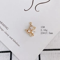 Detail view of gold-plated butterfly pendant with clear zircons on white display card - Teardrop Butterfly (15#)