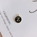 Detail of round black enamel pendant with gold-plated letter Z for DIY jewelry - Letter Z