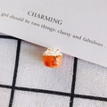 Macro detail of hand-painted orange ceramic fortune cat bead on checkered background - Orange Patchwork Floral Style (5#)
