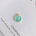 Detail of round gold Z-letter charm with light blue enamel for DIY jewelry making - Letter Z