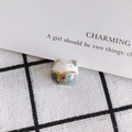 Close-up of a handmade ceramic fortune cat bead with floral patterns and gold details - Cyan Gray Style (6#)