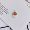 Macro view of green enamel mushroom pendant with pink flower on artistic card - Emerald Green (1#)