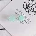 Close-up of light green star-shaped resin ear studs with subtle shimmering glitter finish - Light Green (2#)