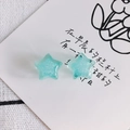 Macro view of light blue acrylic star earrings with fine glitter and translucent finish - Light Blue (7#)