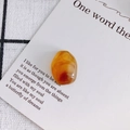 Macro shot of an amber irregular translucent stone pendant with fine polished texture - Style 1