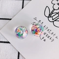 Close-up of clear resin beads with colorful iridescent glitter filling for DIY jewelry making - Rainbow Flakes (2#)
