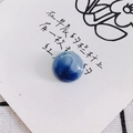 Close-up of a blue marbled glass cabochon flatback bead for DIY jewelry and crafts - Deep Blue Swirl Style (11#)