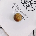 Detailed view of a round amber marble resin bead on a decorative white card with floral art - Warm Brown Marble Style (17#)
