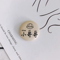 Minimalist beige leather button accessory featuring a cute cartoon boy and xiao ge ge text - 22# Off-White