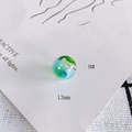 Macro view of 13mm hollow glass bead with blue and green swirl pattern details - 9# Style (KP4175)
