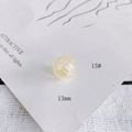 Macro shot of 13mm transparent glass bead with yellow spiral wave patterns for DIY jewelry - 15# Style (KP4175)