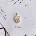 Detail view of a 20x12mm gold skull pendant with shell inlay on a white card background - Gold Skull Style (3#)