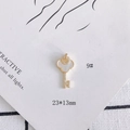 Detailed view of an 18k gold-plated key pendant with shell clover and small crystals - Clover Shell Key Style (9#)