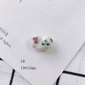 Macro shot of 19x15mm handmade ceramic oval bead with pink floral and gold accents - Pink Flower Painted Style (1#)