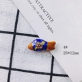 Detail view of 26x12mm handmade blue ceramic fish bead with floral pattern and orange fins - Dark Blue and Orange Enamel Style (4#)