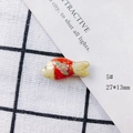 Macro shot of 27x13mm red handmade ceramic fish pendant with floral patterns and gold edges - Red and White Floral Gold Edge (5#)