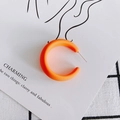 Macro shot of matte orange C-shaped acrylic hoop earrings on artistic jewelry card - Orange (1#)