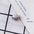Macro shot of 18x14mm handmade lavender ceramic fish bead with orange accents - Light Purple Orange Stripes (10#)