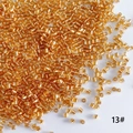 Macro shot of 2mm silver-lined golden glass bugle beads for DIY jewelry making - 50g (Approx. 5200 Pcs) / Champagne Gold (13#)