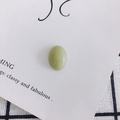 Close-up of light green oval resin cabochon with smooth polished finish for DIY crafts - Pale Green (5#)