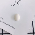 Detailed view of an oval white resin cabochon bead for DIY shoe and phone case decor - Creamy White (6#)