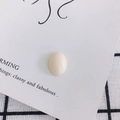 Macro detail of smooth oval resin cabochon for DIY phone case and shoe charms - Cream (14#)