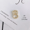 Macro detail of a 24x16mm golden rabbit pendant with pearls and zircon stones - Size 6