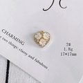 Macro detail of heart-shaped pendant with floral shell inlay and rhinestones, 17x17mm size - Size 7