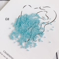 Close-up of 2mm light blue glass seed beads on minimalist decorative paper card - 450g Pack (Approx. 57600 Pcs) / Size 6