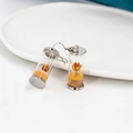 Detailed view of handmade glass bottle earrings featuring orange dried flowers inside - Orange