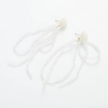Macro view of white floral stud earrings with cascading clear beaded long tassels - White Flower