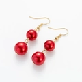 Detail of red faux pearl cherry earrings with golden metal hooks on white background - Red Pearl (Retro Oval)