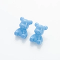 Macro detail of cute light blue resin bear earrings with glossy pearlescent finish - Blue
