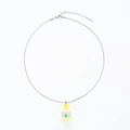 Macro detail of drift bottle pendant necklace with green floral design and silver snake chain - Stainless Steel Yellow