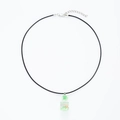 Close-up of drifting bottle necklace with green filler and orange flower pendant - Cord Green