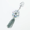 Macro shot of colorful crystal flower keychain with long beaded tassel and silver clasp - Royal Blue