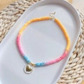 Bohemian colorful heishi bead necklace with gold heart pendant on white ceramic tray - Orange Pink Blue Clay-White Heart (Style C)
