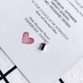 Macro detail of rectangle purple zircon charm with gold plating on a decorative card - Deep Purple (1)