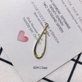 Detail view of a 40x13mm gold plated hollow teardrop metal pendant with a connector loop - Shiny Gold Long Teardrop Hollow Pendant (9)